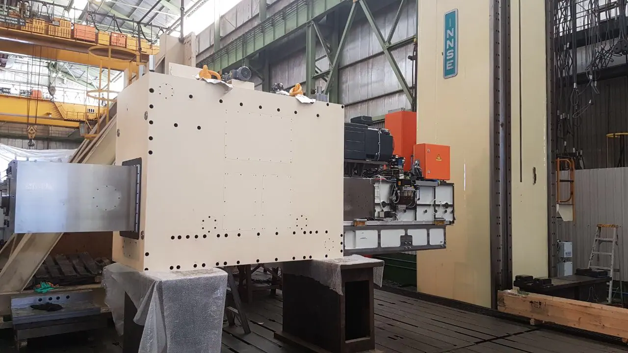 Technicians working around a large boring mill during assembly