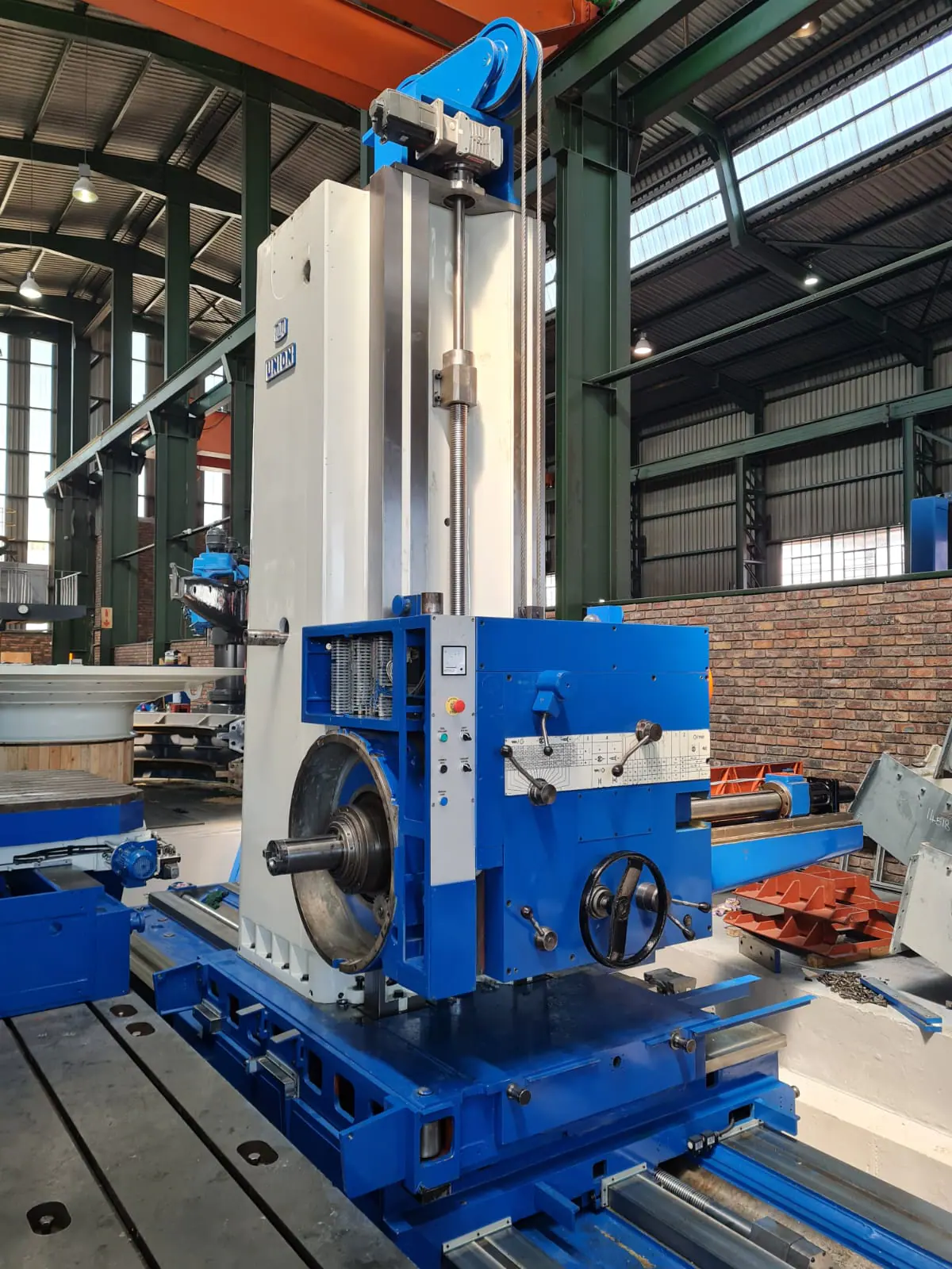Large blue and white horizontal boring machine in a workshop